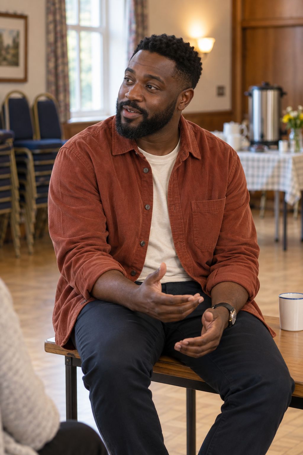 Kwame Mensah, head of community programs, talking in a community hall